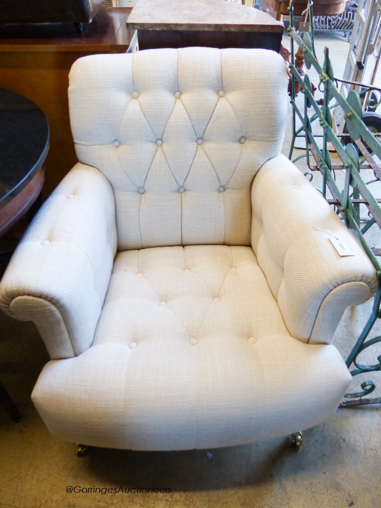 A Laura Ashley armchair upholstered in buttoned natural fabric, width 82cm, depth 90cm, height 86cm